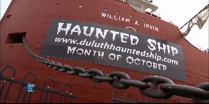 The historic William A. Irvin ship docked in Duluth, illuminated at night with spooky lighting.